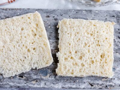 two slices of white bread on a gray slate tile