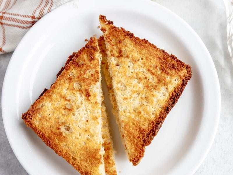 toast cut diagonally on a white plate