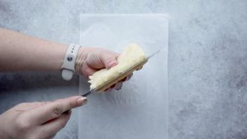 slicing bread in half with a knife