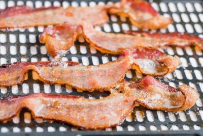 crispy bacon on an air fryer basket