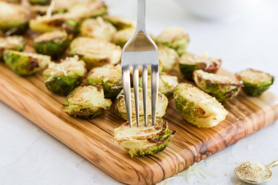 a fork stabbing a crunchy brussels sprout