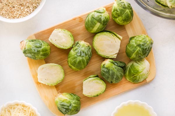 brussels sprouts cut in half on a cutting board