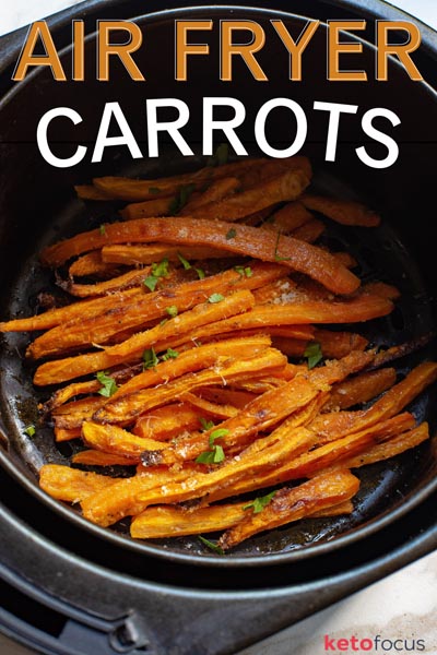 Close up of cooked carrots in an air fryer basket.