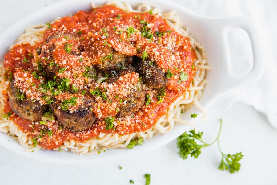 lots of big meatballs on keto pasta with parmesan cheese