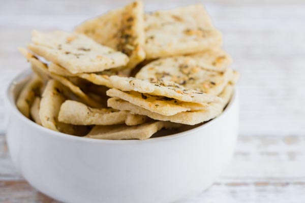 a bunch of keto crackers in a small white bowl