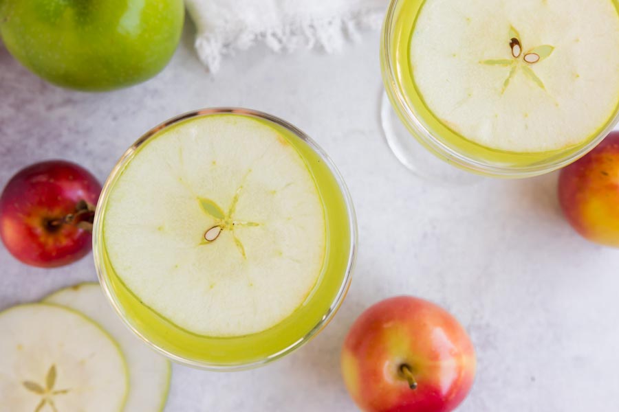 a slice of apple in each cocktail glass