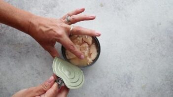 Opening a can of canned chicken to make an easy Chinese chicken salad recipe.