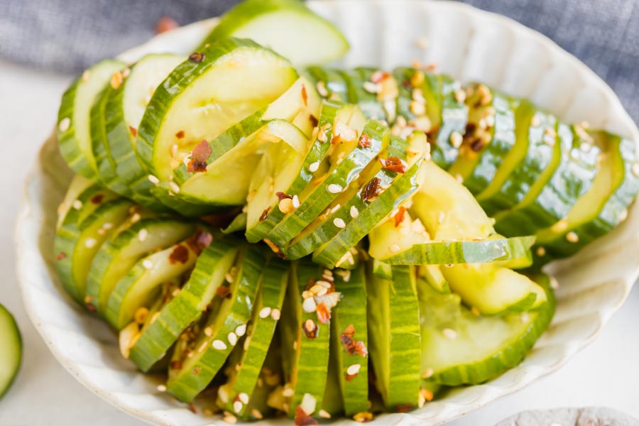 close up of asian marinated cucumbers in a bowl