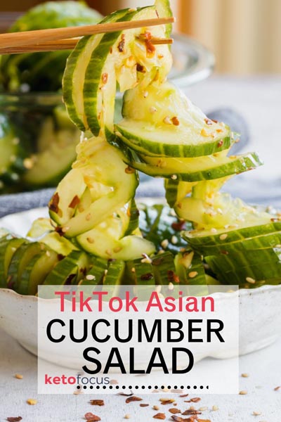 holding a marinated tiktok cucumber salad with chopsticks