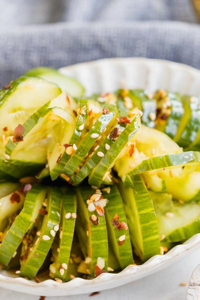 green cucumber salad topped with sesames and red pepper flakes