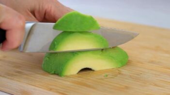 slicing an avocado with a knife