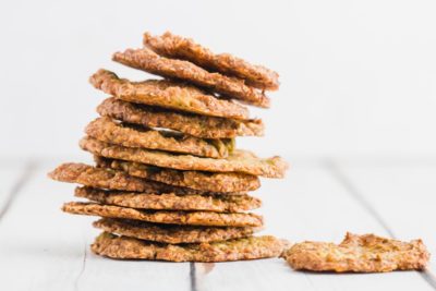 a leaning stack of avocado crackers on a white board