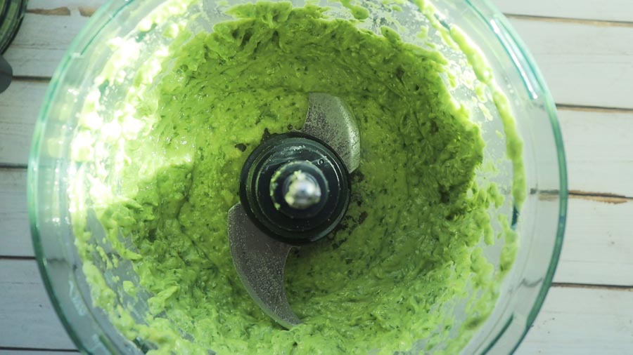 blended avocado pesto sauce in a food processor