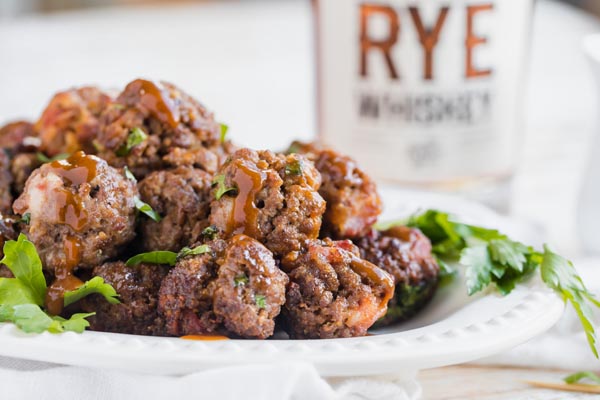 bourbon meatballs with a bottle of whiskey in the background
