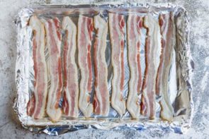 raw bacon on a foil lined tray