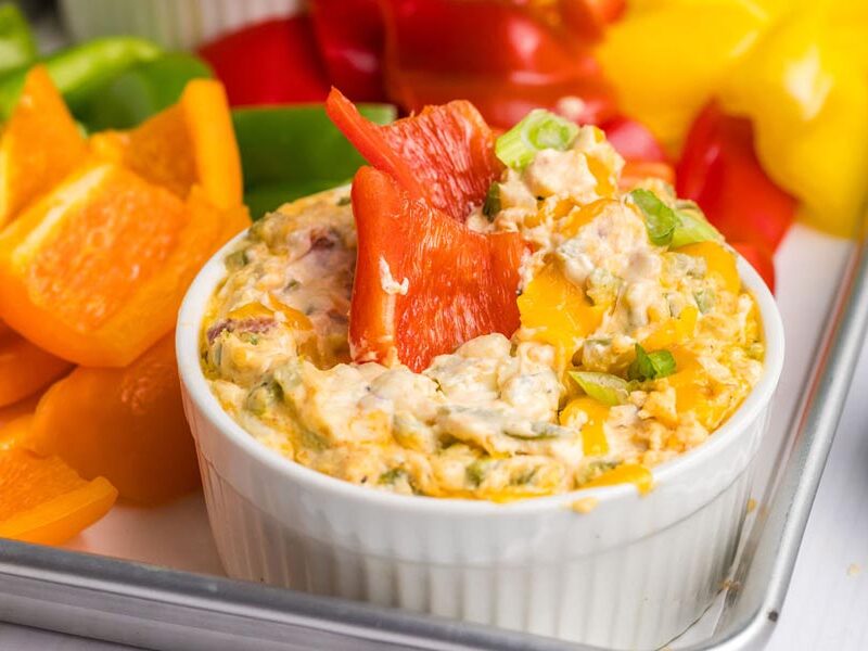 Slices of bell pepper sitting in a creamy dip.
