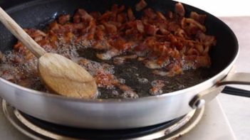 crispy bacon cooking in a skillet
