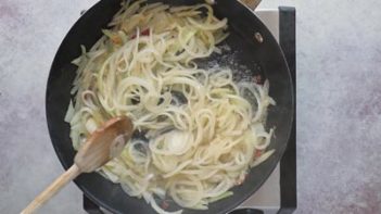 sautéing sliced onions in a skillet
