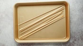 wooden skewers soaking in a tray of water