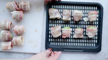 8 bacon wrapped brussels sprouts in an air fryer tray