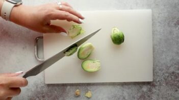 cutting brussels sprouts in half with a knife