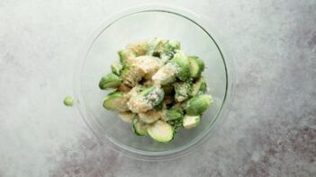 a bowl with brussels sprout and grated parmesan cheese