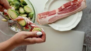 threading a sprout on a skewer with bacon