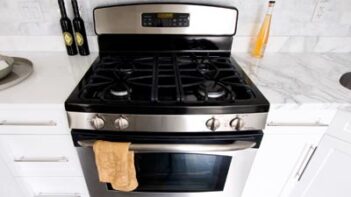 A range stovetop and oven in a white chicken.