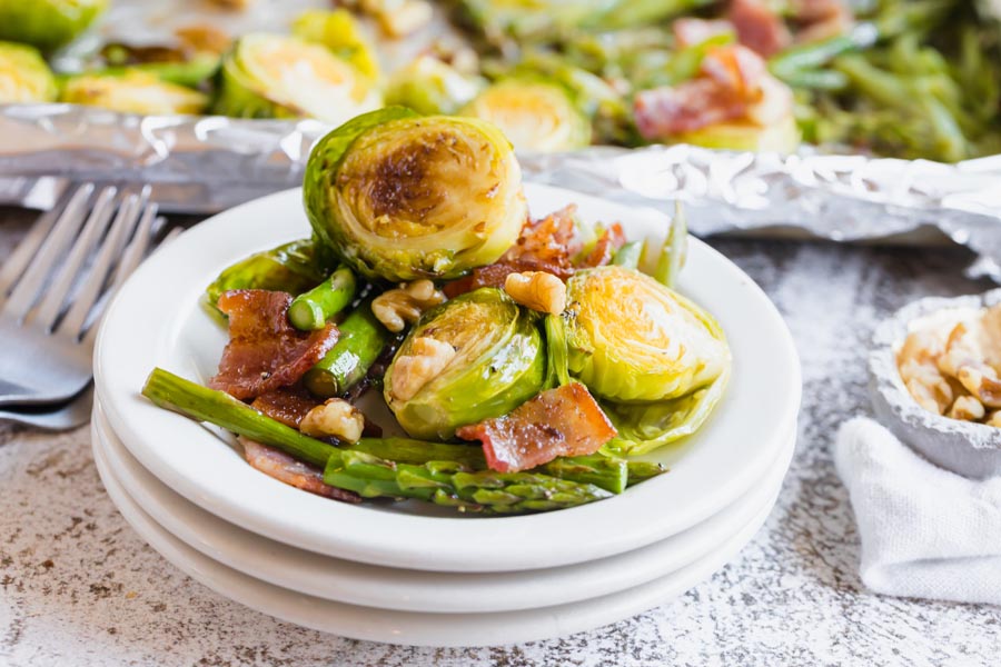 a plate with baked brussels sprouts, vegetables on bacon on it for dinner