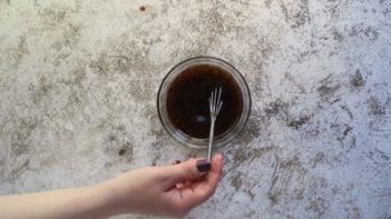 whisking a balsamic dressing with a small whisk