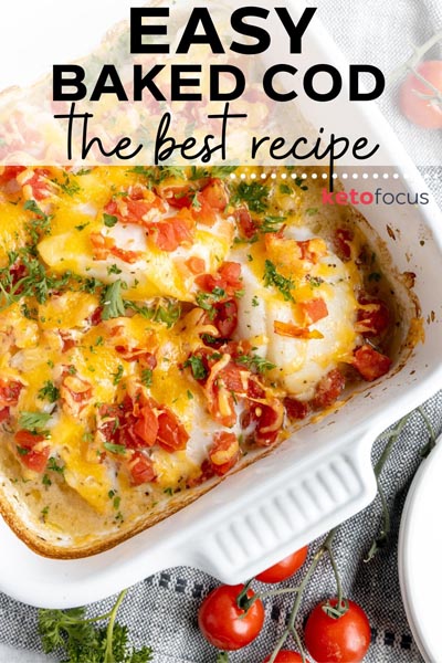 pieces of baked cod in a baking dish topped with cheddar cheese and chunks of tomato
