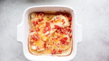 melted cheese and diced tomatoes over baked fish