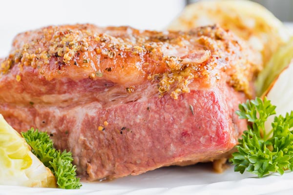 whole brisket of beef next to parsley and cabbage