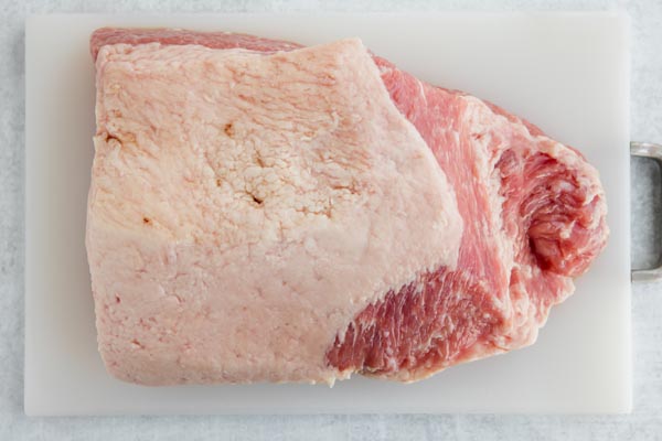 a slab of corned beef brisket on a cutting board