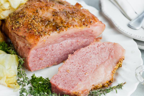 a sliced off piece of corned beef brisket on a platter