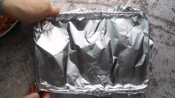 placing foil over a casserole pan