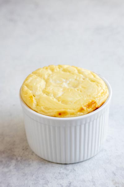 Single-serve baked yogurt prepared in a white ramekin with a lightly golden top.