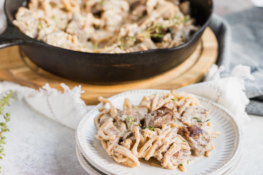 a plate with a creamy noodle pasta on it