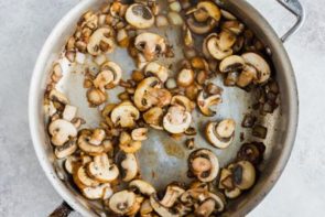 mushrooms and onion cooking a skillet