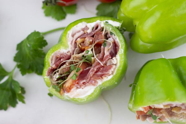 looking down onto a bell pepper cut in half and filled with sandwich fixings