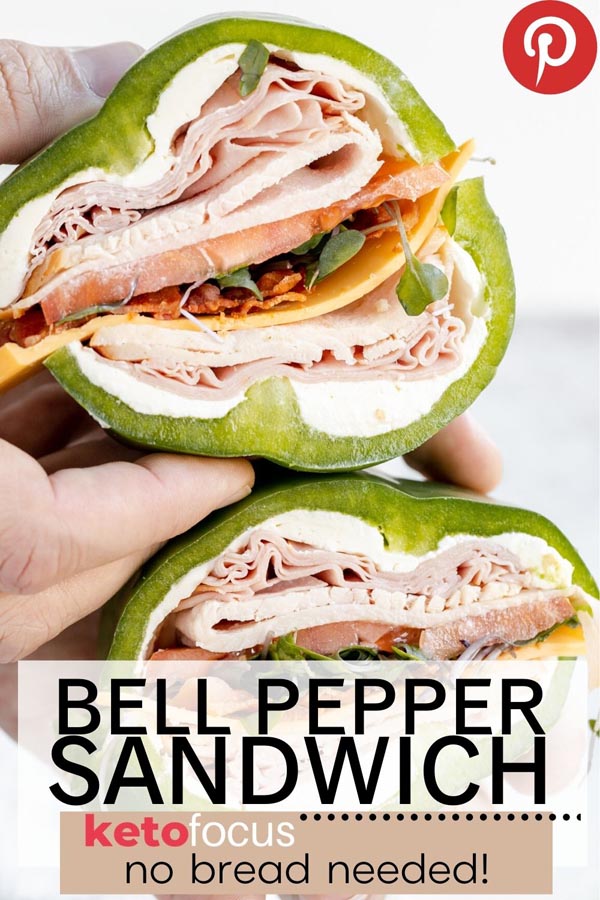hold a bell pepper sandwich cut in half filled with turkey, ham, cream cheese