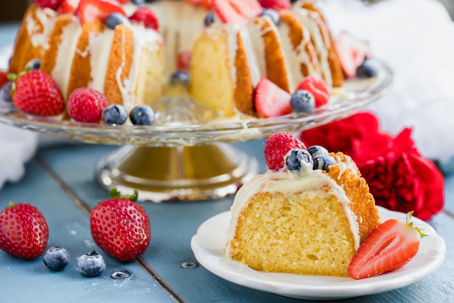 a slice of bundt cake on a plate with the whole cake behind