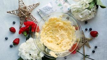 creamed butter in a bowl next to gold stars and berries