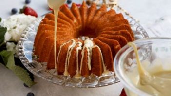 drizzling melted white chocolate over a star shaped bundt cake