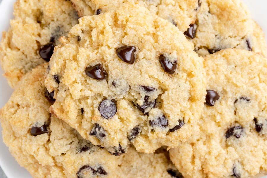 a pile of chocolate chip cookies stacked on each other with melty chips in the center