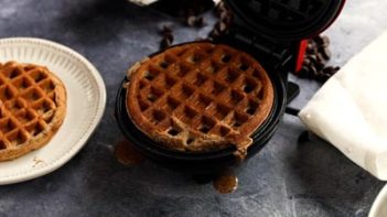 a chocolate waffle cooking in a waffle maker