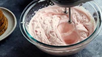 beating whipped cream frosting with an electric mixer