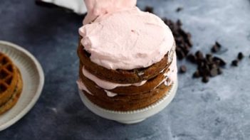 frosting a waffle cake with pink frosting