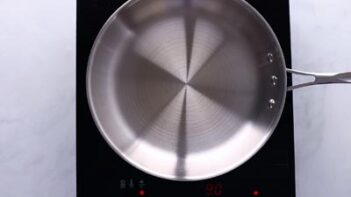 A stainless steel skillet on an induction burner.