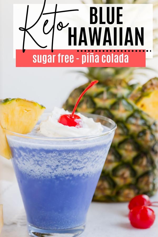 a keto cocktail that is frozen and blue in front of a big pineapple